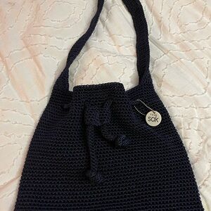 The Sak Navy Crochet Drawstring Shoulder Bag with Logo Charm